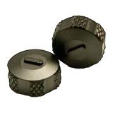 a pair of metal knobs on a black background